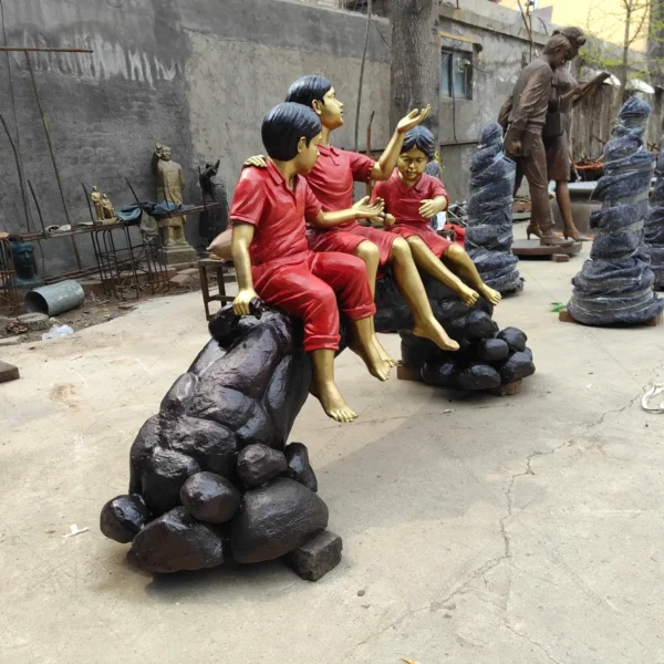 three children on log statue