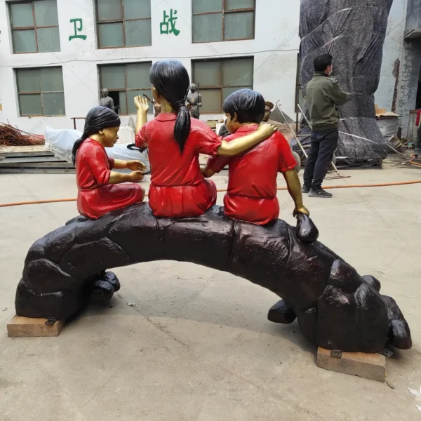 three children on log statue