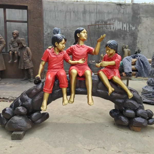 three children on log statue