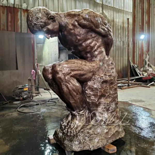 man sitting on rock statue